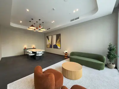 a living room with a green couch and a table at Skyview Experience View Burj Khalifa Pool, Canal in Dubai