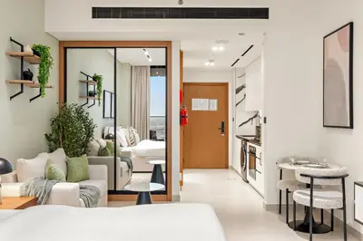 a living room with a couch and a table at FIRST CLASS Studio Private Jacuzzi Canal View in Dubai