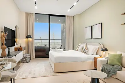 a bedroom with a king sized bed and a living room at FIRST CLASS Studio Private Jacuzzi Canal View in Dubai