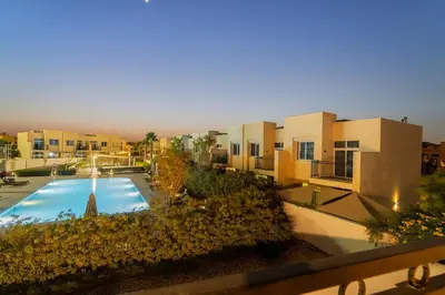 a view of a building with a swimming pool at FIRST CLASS Villa Peaceful Pool View Retreat in Dubai