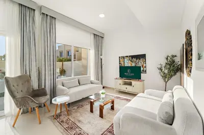 a living room with two couches and a tv at FIRST CLASS Villa Peaceful Pool View Retreat in Dubai