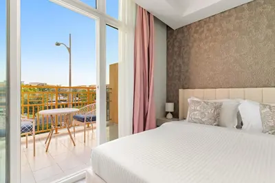 a bedroom with a bed and a balcony at FIRST CLASS VILLA Zen Luxe Contemporary Haven in Dubai
