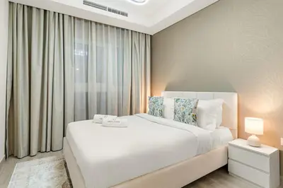a bedroom with a white bed and a window at FIRST CLASS VILLA Zen Luxe Contemporary Haven in Dubai