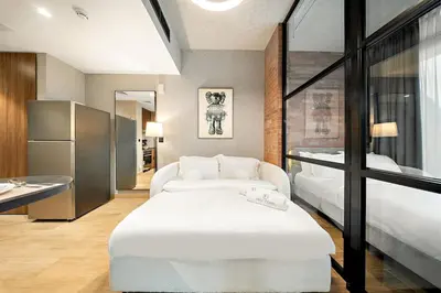 a bedroom with a large white bed and a large window at FIRST CLASS 1BR Elegant Cozy Escape in Dubai
