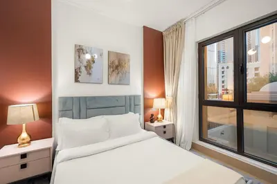 a bedroom with a bed and a large window at FIRST CLASS 2BR Old Town Burj View Retreat in Dubai