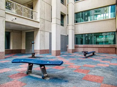 a blue bench in front of a building at FIRST CLASS 1BR Sophisticated Downtown Escape in Dubai