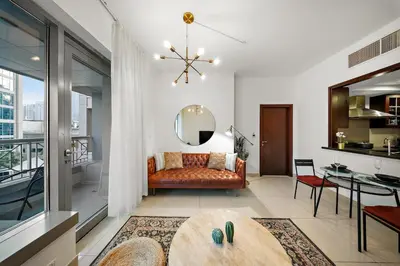 a living room with a couch and a table at FIRST CLASS 1BR Sophisticated Downtown Escape in Dubai