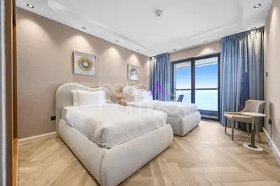 a hotel room with two beds and a chair at Amazing 2BR Princess Tower Dubai Marina in Dubai