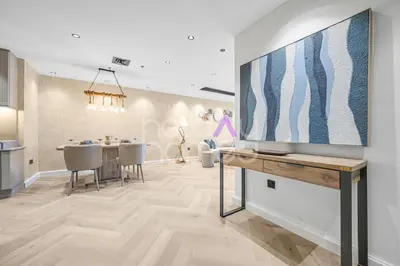 a living room with a large tv on a wall at Amazing 2BR Princess Tower Dubai Marina in Dubai