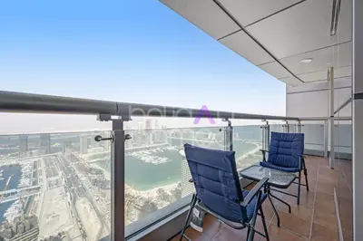 two blue chairs sitting on top of a building at Amazing 2BR Princess Tower Dubai Marina in Dubai