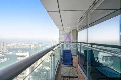 a balcony on the top of a building with chairs at Amazing 2BR Princess Tower Dubai Marina in Dubai