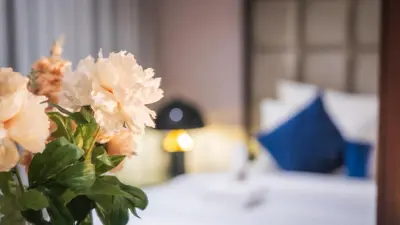 a vase filled with white flowers on a table at Downtown Dubai Mall Walkable 8 min in Dubai