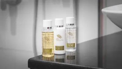 three bottles of essential oils sitting on a counter at Downtown Dubai Mall Walkable 8 min in Dubai