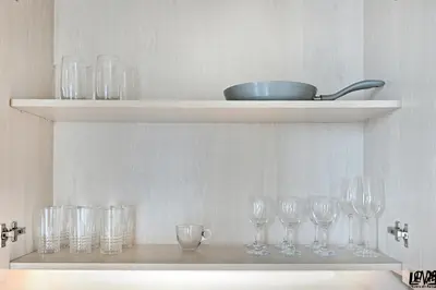 a shelf with wine glasses and a bowl on it at Peaceful, Unique 1BR Experience ,Dubai Marina in Dubai