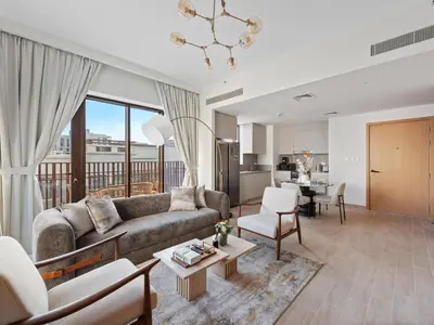 a living room with a couch and a table at Luxury Elegance 2BDR In Sunset-Creek Beach-03 in Dubai