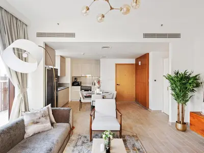 a living room with a couch and a table at Luxury Elegance 2BDR In Sunset-Creek Beach-03 in Dubai