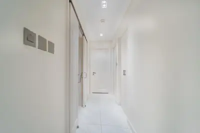 an empty hallway with white walls and white floors at Zaafaran 1- Luxury 2BR Apt Near Burj Khalifa & Dubai Mall in Dubai