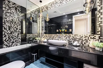 a black bathroom with a sink and a mirror at Ultra-Luxe Breathtaking Canal Views l Business Bay in Dubai