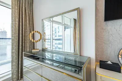 a dressing room with a mirror and a window at Ultra-Luxe Breathtaking Canal Views l Business Bay in Dubai