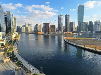 a view of a river in a city with tall buildings at Ultra-Luxe Breathtaking Canal Views l Business Bay in Dubai