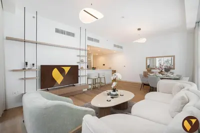 a living room with two white couches and a tv at Vogue Al Wasl 1 Residences Near Zabeel Park and World Trade Centre, Two Bedroom Apartment with Balcony with City View, Access to all Amenities, Walkable to Max Fashion Metro Station in Dubai