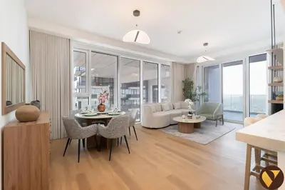a living room with a couch and a table and chairs at Vogue Al Wasl 1 Residences Near Zabeel Park and World Trade Centre, Two Bedroom Apartment with Balcony with City View, Access to all Amenities, Walkable to Max Fashion Metro Station in Dubai