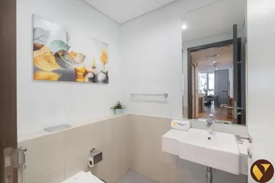 a white bathroom with a sink and a mirror at Vogue Al Wasl 1 Residences Near Zabeel Park and World Trade Centre, Two Bedroom Apartment with Balcony with City View, Access to all Amenities, Walkable to Max Fashion Metro Station in Dubai
