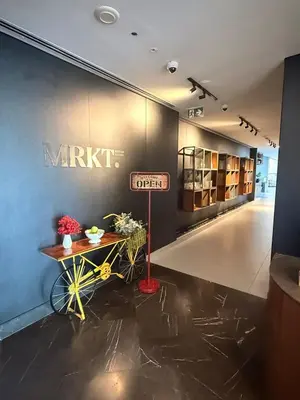 a lobby with a market sign on the wall at Novotel JVT Studio 5 Star Amenities Access in Dubai