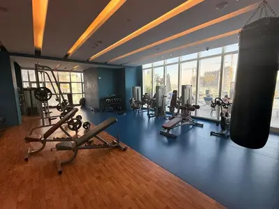 a gym with a bunch of treadmills and machines at Novotel JVT Studio 5 Star Amenities Access in Dubai