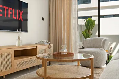 a living room with a tv and a coffee table at VayK - Modern 4 BD Townhouse with Private Garden in Damac Lagoons in Dubai