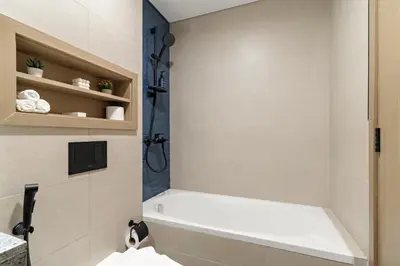a bathroom with a white tub and a shower at VayK - Modern 4 BD Townhouse with Private Garden in Damac Lagoons in Dubai