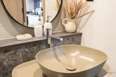 a bathroom with a sink and a mirror at Réveille Face au Burj Khalifa Vu Canal & Piscine in Dubai