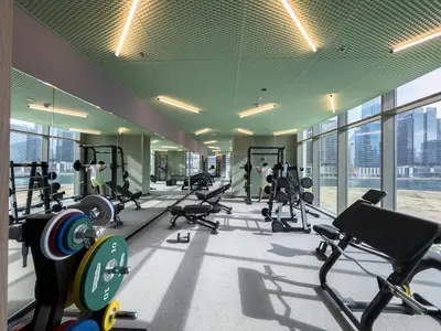 a gym with treadmills and machines in a building at Réveille Face au Burj Khalifa Vu Canal & Piscine in Dubai