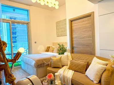 a living room with a bed and a couch at Barsana - Seabreeze Suite - 2 Bed - Sea Views in Dubai
