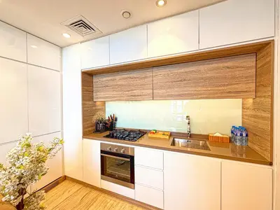 a kitchen with white cabinets and a sink at Barsana - Seabreeze Suite - 2 Bed - Sea Views in Dubai