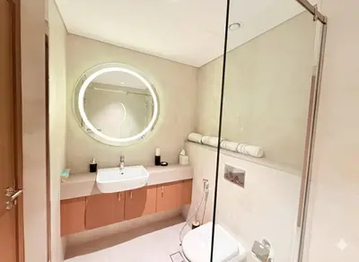 a bathroom with a sink and a mirror at City Glow Comfort Studio - Oasis Pool in Dubai