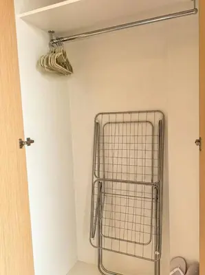 a wire basket in the corner of a bathroom at Palm Horizon | Luxury Anantara Studio in Dubai