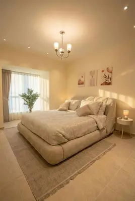 a large bed in a large bedroom with a chandelier at Skyline Escape | Marina High-Floor 1BR Apartment in Dubai