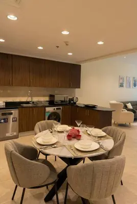 a kitchen with a table and chairs in a room at Skyline Escape | Marina High-Floor 1BR Apartment in Dubai