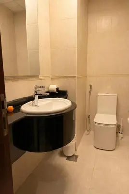 a bathroom with a sink and a toilet at Skyline Escape | Marina High-Floor 1BR Apartment in Dubai