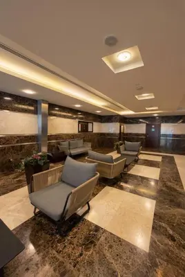 a lobby with couches and chairs in a building at Skyline Escape | Marina High-Floor 1BR Apartment in Dubai
