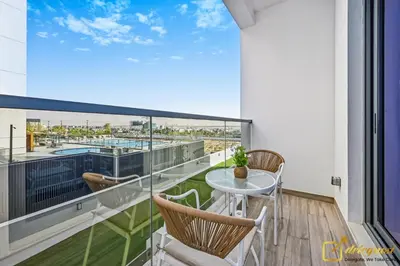 a balcony with a table and chairs and a view at Luxury Studio in Dubai Hills by Deleguest in Dubai