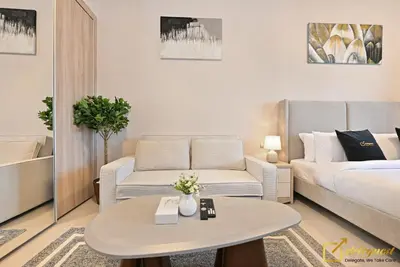 a living room with a couch and a table at Luxury Studio in Dubai Hills by Deleguest in Dubai