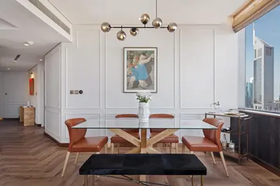 a dining room with a glass table and chairs at Sky-high luxury in DIFC I new and modern in Dubai