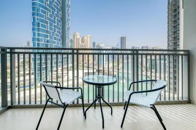 two chairs and a table on a balcony with a view at Luxury Sea View 1BR in JBR with easy Bluewaters Access in Dubai