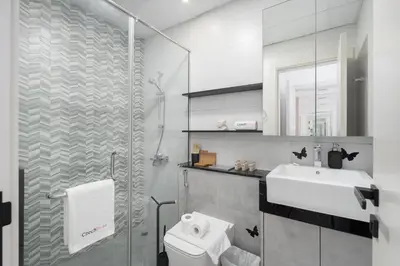 a bathroom with a toilet and a sink and a shower at Luxury 1BR Apartment in Binghatti Mirage JVC Dubai in Dubai