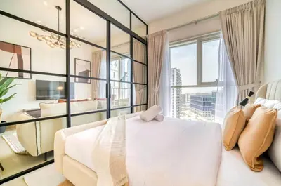 a bedroom with a white bed and a large window at Stunning 1 B R in Dubai Hills in Dubai