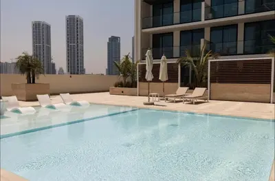 a large swimming pool on the roof of a building at Amazing Amenities Studio JVC Gym Near Mall in Dubai