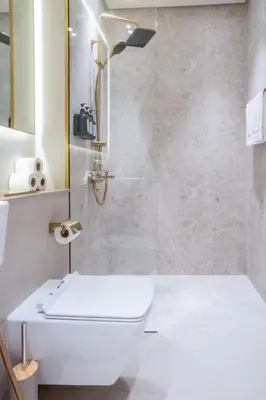 a bathroom with a shower with a toilet and a sink at Elegant JVC Studio I Gym Access I Prime Location in Dubai