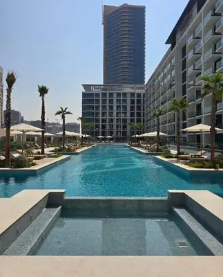 a large swimming pool in front of a building at Stylish 2Bedroom JVC I Comfort I Epic Pool in Dubai